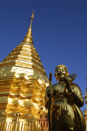 Statue and gilded stupa at Wat Phra That Doi Suthep temple.