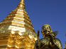 Statue and gilded stupa at Wat Phra That Doi Suthep temple.