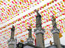 Statues at Basillica Minore del Santo Nino, with rows of flags overhead.