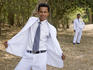 Groomsman and groom pose at wedding function in grounds of Angkor Wat.