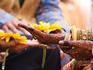 Bejewelled bride with henna hands at Mumbai wedding.