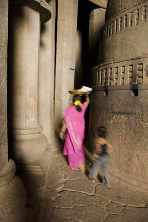 People walking through Karla Buddhist Caves.