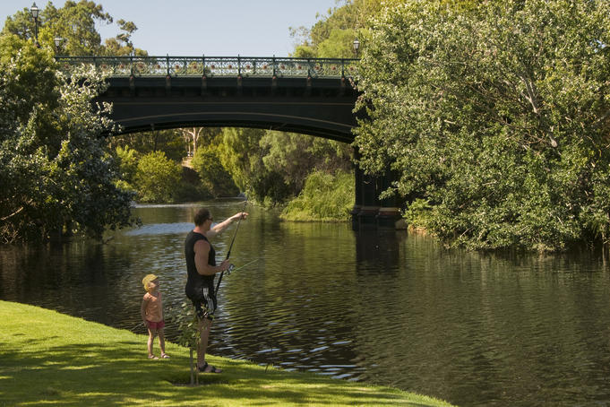 Fishing on north bank of River Torrens, with heritage-listed Albert Bridge in background.