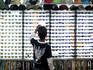 Customer at sunglass stall at Kata Beach evening market.