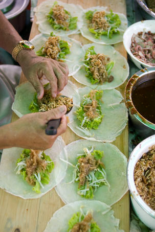 Vendor making Phuket-style spring rolls.