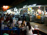 People eating at restaurant at night market.