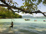 Young boy on rope swing at Tri Trang beach.