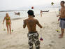 Tattooed Thai man teaching travellers new hobby, Hat Chaweng.