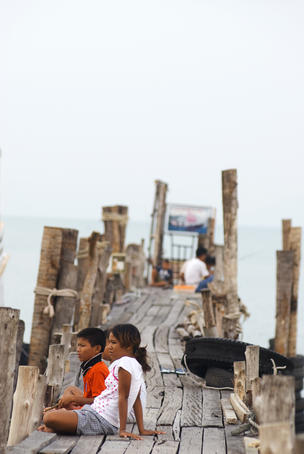 Children waiting for boats at pier.