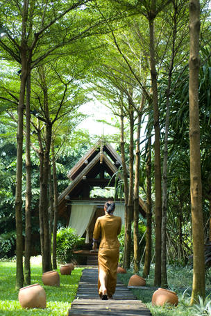 Thai woman walking at the Spa at Anantara Ko Samui.