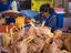 Poultry cleaners preparing meat at main market.