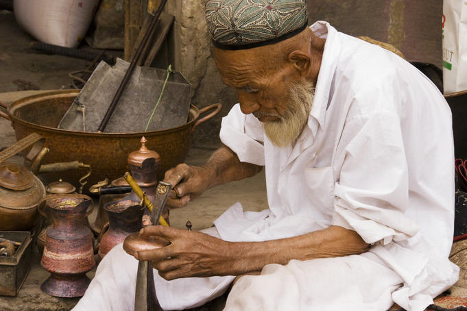 Uighur coppersmith at work.