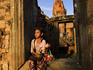 Young girl sitting in stone doorway, Pre Rup.