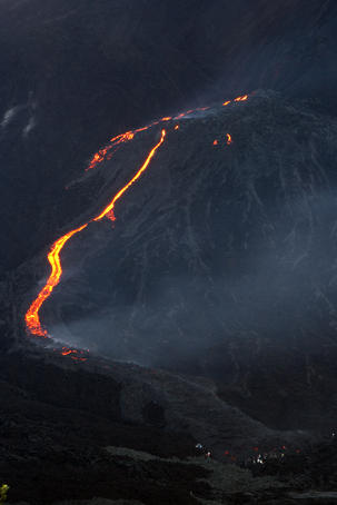Group of tourists heading towards lava river in Pacaya Volcano.