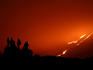 Climbers watching lava flowing down Pacaya Volcano.