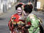 Geisha checking photos on digital camera.