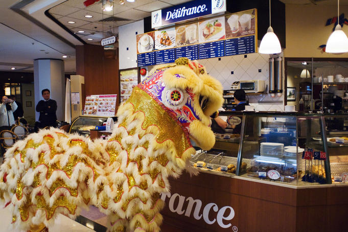 Lion dance at store in shopping mall, North Point.