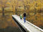 Mother and child on wooden jetty with autumn colours on lake's edge, Sailors Cutting.