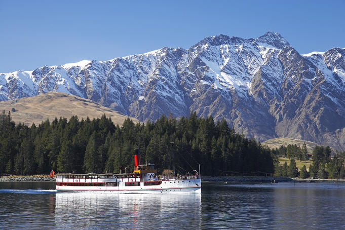 TSS Earnslaw sailing on Lake Wakatipu, with The Remarkables in background.