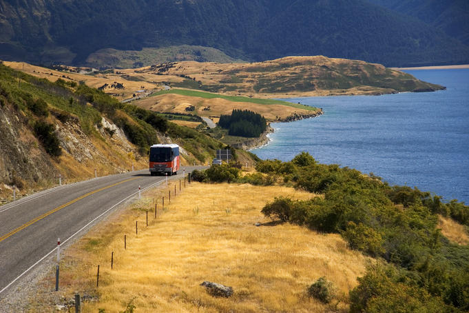 Tour bus climbing hill by Lake Wanaka.