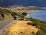 Tour bus climbing hill by Lake Wanaka.