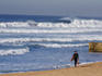 Boogie boarder walking from surf at Ansteys Beach.