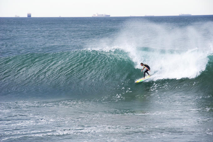 Surfer on wave off Durban pier.