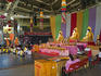 Monks and devotees praying before Buddha statues in Suncorp Piazza at Buddha Birth Day Festival.