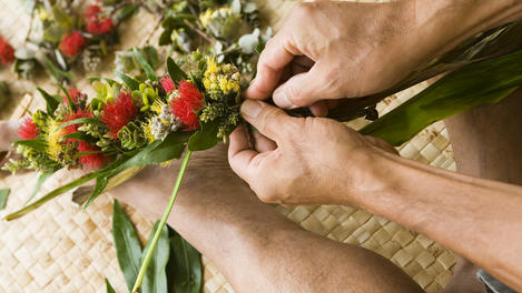 Master lei maker, Kilohana Domingo making a braided lei of lehua flowers at Kalaelilohana Bed and Breakfast, Ka'u.