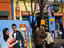 La Boca street scene, with couple posing at a head-through-the hole photo board.