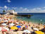 Beach umbrellas and bathers on the crowded beach of Porto da Barra.