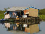 House and boats in Chong Kneas floating village on Tonle Sap lake.
