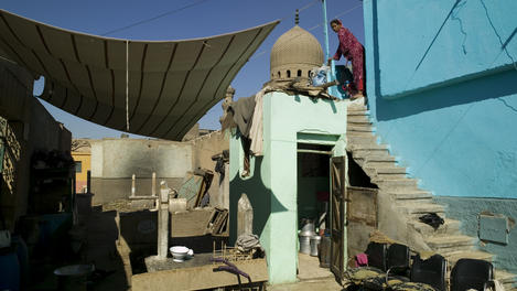 Woman cleaning her house in the Northern Cemetery, Bab el Nasr.