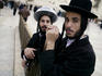 Jewish men gathering before their most sacred shrine, the Western Wall.