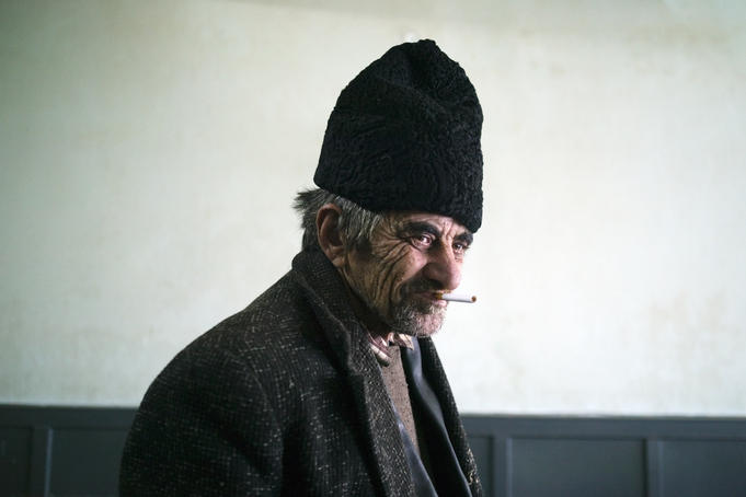 Gypsy man smoking in a bar in Transylvania.