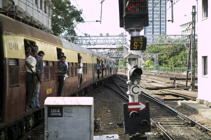 Passengers on board the crammed train service near Howrah Station.