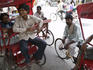 Rickshaw pullers having a laugh together while on a break.