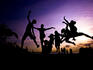 Kids jumping in sunset silhouette, Sentosa.