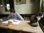 Man reading near cat on table at Jenever cafe De Vagant on Reyndersstraat.