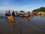 Wooden boats moored on shore of Karon Beach.
