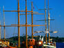 Old sailing ships on the harbour beneath a blue sky