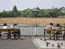 People on park benches with Benten-Do temple in background, Ueno Koen.