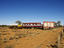 Roadside signs with old truck and train for National Road Transport Hall of Fame and Old Ghan Museum.