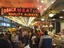 Crowded Pikes Place seafood market interior.