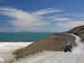 Pick-up truck driving on dirt road near salt flats at Sea of Cortez coastline south of Puertecitos.