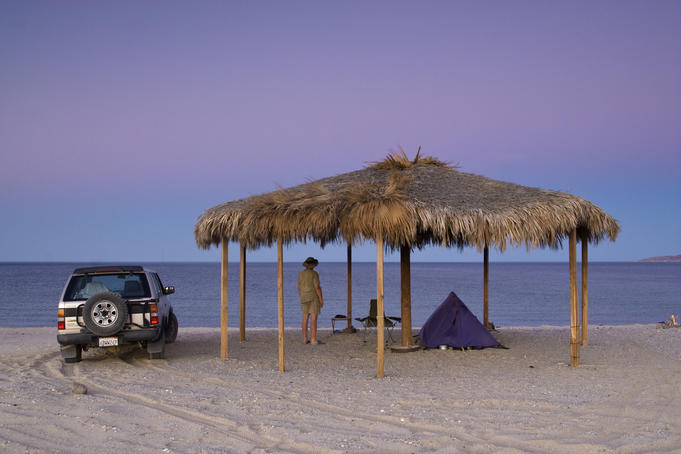 Camper underneath palapa at Campo Rancho Grande after sunset.