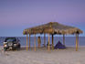 Camper underneath palapa at Campo Rancho Grande after sunset.