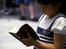 Young girl reading a Chinese Bible at Community Church.