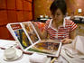 Young woman looking through the menu at Shanghai Uncle restaurant.