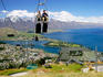 Luge riders taking lift up to top of hill, looking out over Queenstown and Lake Wakatipu.